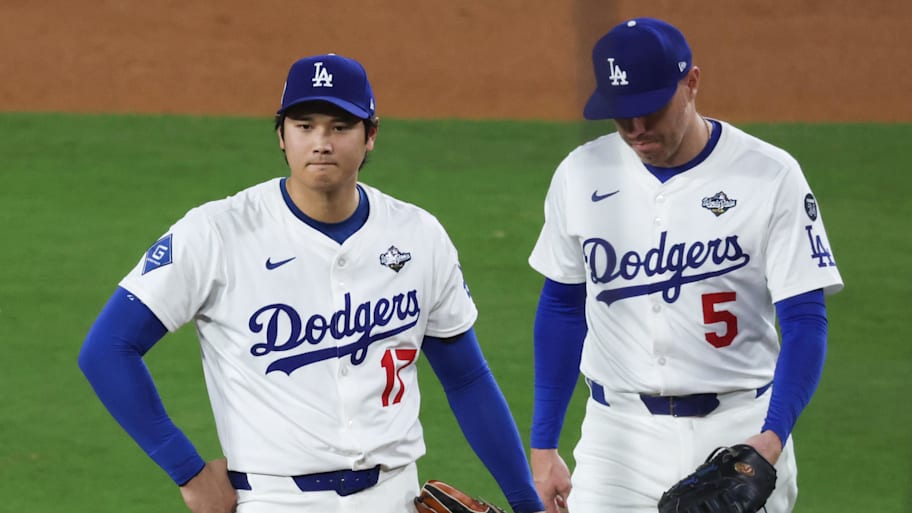 Los Angeles Dodgers two-way player Shohei Ohtani, left, is taken out of 2025 World Series Game 4.