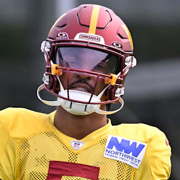 Aug 6, 2025; Foxborough, MA, USA; Washington Commanders quarterback Jayden Daniels (5) with the ball at training camp at Gillette Stadium. Mandatory Credit: Eric Canha-Imagn Images