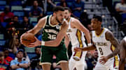 Apr 6, 2025; New Orleans, Louisiana, USA; Milwaukee Bucks forward Pete Nance (35) looks to pass against New Orleans Pelicans forward Jamal Cain (8) during the second half at Smoothie King Center. Mandatory Credit: Stephen Lew-Imagn Images