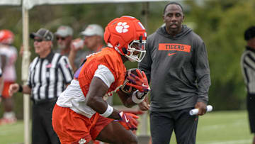 Clemson running backs coach C.J. Spiller watches running back Adam Randall (8) with the ball during Clemson football 2025 practice at the Allen N. Reeves Football Complex in Clemson, S.C. Friday, August 1, 2025.