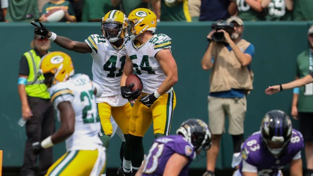 Green Bay Packers lnebacker Kristian Welch (54) celebrates with Gemon Green after Welch intercepted a pass against the Ravens