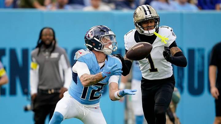 Tennessee Titans wide receiver Mason Kinsey (12) receives a pass past New Orleans Saints cornerback Alontae Taylor (1) during the third quarter at Nissan Stadium in Nashville, Tenn., Sunday, Dec. 28, 2025.