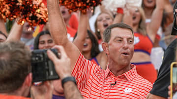 Clemson head coach Dabo Swinney cheers with cheerleaders, Central Spirit and ClemsonLIFE during Good Morning America’s 50 States in 50 Days host Will Reeve leads a show in Memorial Stadium in Clemson, S.C. Thursday, August 21, 2025.