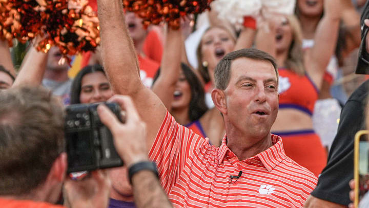 Clemson head coach Dabo Swinney cheers with cheerleaders, Central Spirit and ClemsonLIFE during Good Morning America’s 50 States in 50 Days host Will Reeve leads a show in Memorial Stadium in Clemson, S.C. Thursday, August 21, 2025.