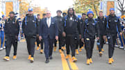 Oct 25, 2025; Pittsburgh, Pennsylvania, USA; Pittsburgh Panthers head coach Pat Narduzzi (middle) leads the Panthers to the stadium to play the North Carolina State Wolfpack at Acrisure Stadium. Mandatory Credit: Charles LeClaire-Imagn Images