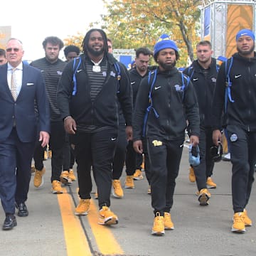 Oct 25, 2025; Pittsburgh, Pennsylvania, USA; Pittsburgh Panthers head coach Pat Narduzzi (middle) leads the Panthers to the stadium to play the North Carolina State Wolfpack at Acrisure Stadium. Mandatory Credit: Charles LeClaire-Imagn Images