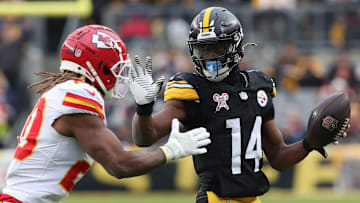 Dec 25, 2024; Pittsburgh, Pennsylvania, USA;  Pittsburgh Steelers wide receiver George Pickens (14) runs after a catch as Kansas City Chiefs safety Justin Reid (20) defends during the fourth quarter  at Acrisure Stadium. Mandatory Credit: Charles LeClaire-Imagn Images