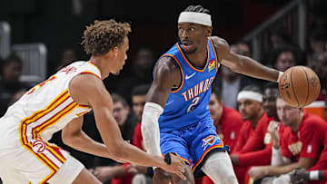 Oct 25, 2025; Atlanta, Georgia, USA; Oklahoma City Thunder guard Shai Gilgeous-Alexander (2) controls the ball against Atlanta Hawks guard Dyson Daniels (5) during the first half at State Farm Arena. Mandatory Credit: Dale Zanine-Imagn Images