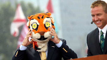 TV personality Lee Corso puts on a Tiger Mascot head near Kirk Herbstreit inside the ESPN Gameday