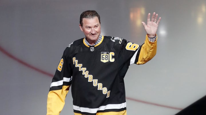 Feb 18, 2024; Pittsburgh, Pennsylvania, USA;  Pittsburgh Penguins former center Mario Lemieux waves to the crowd during a ceremony to retire the jersey number of Penguins former right wing Jaromir Jagr (not pictured) at PPG Paints Arena. The Penguins hosted the Los Angeles Kings after the ceremony. Los Angeles won 2-1. Mandatory Credit: Charles LeClaire-USA TODAY Sports