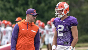 Clemson offensive coordinator Garrett Riley and quarterback Cade Klubnik (2) talk during Clemson football 2025 practice at Jervey Meadows in Clemson, S.C. Wednesday, August 6, 2025.