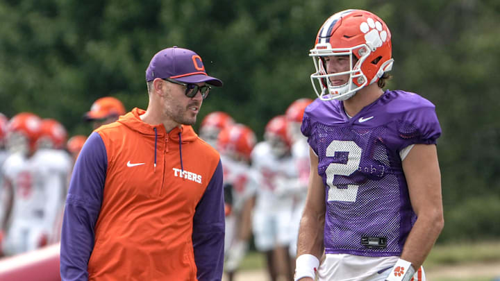 Clemson offensive coordinator Garrett Riley and quarterback Cade Klubnik (2) talk during Clemson football 2025 practice at Jervey Meadows in Clemson, S.C. Wednesday, August 6, 2025.