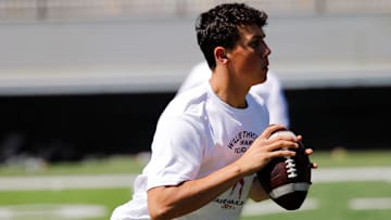 Connellsville senior quarterback Caden Matthews rolls out to throw a pass during a drill at the Will Thrower Award Foundation camp Saturday at Valley High School in New Kensington, Pa. Matthews threw for 700 yards for the Falcons last season before an injury ended his season.