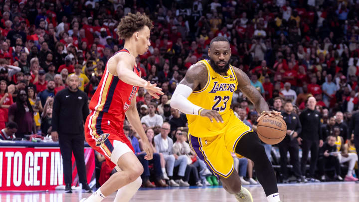 Apr 16, 2024; New Orleans, Louisiana, USA; Los Angeles Lakers forward LeBron James (23) dribbles against New Orleans Pelicans guard Dyson Daniels (11) during the second half of a play-in game of the 2024 NBA playoffs at Smoothie King Center. Mandatory Credit: Stephen Lew-USA TODAY Sports