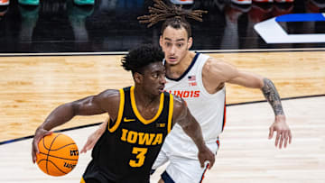Mar 13, 2025; Indianapolis, IN, USA;  Iowa Hawkeyes guard Drew Thelwell (3) dribbles the ball while  Illinois Fighting Illini guard Dra Gibbs-Lawhorn (2) defends in the first half at Gainbridge Fieldhouse. Mandatory Credit: Trevor Ruszkowski-Imagn Images