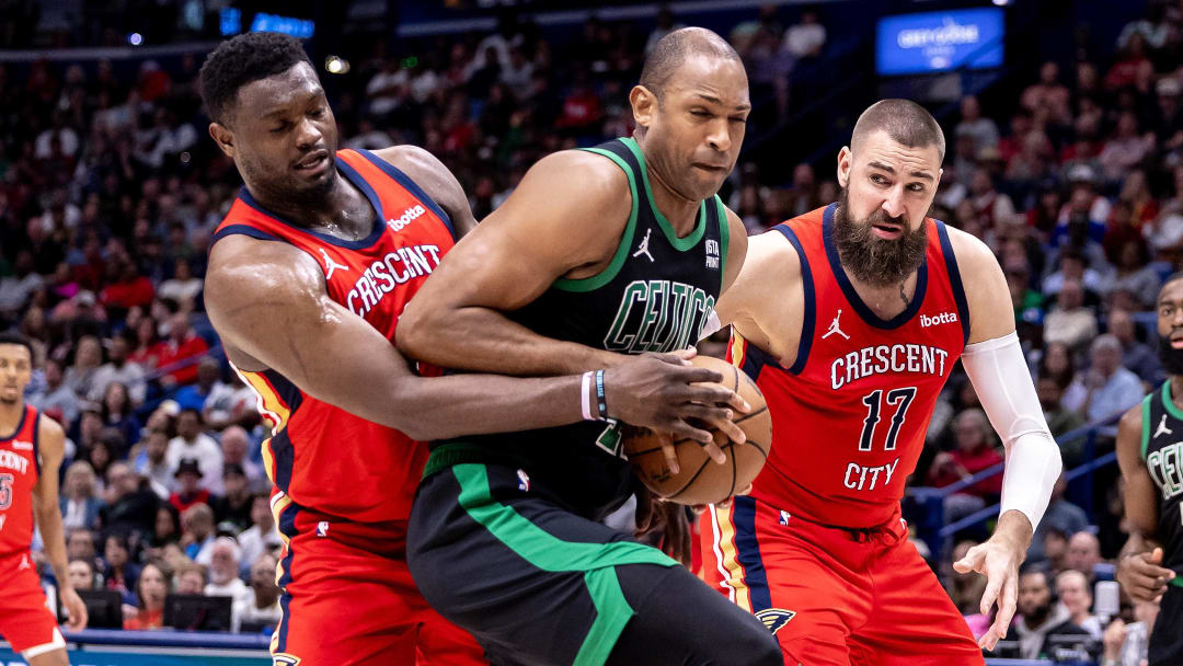 Mar 30, 2024; New Orleans, Louisiana, USA; Boston Celtics center Al Horford (42) is defended by New Orleans Pelicans forward Zion Williamson (1) and center Jonas Valanciunas (17) during the second half at Smoothie King Center.