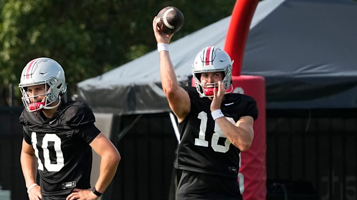 Aug 8, 2024; Columbus, Ohio, USA; Ohio State Buckeyes quarterback Will Howard (18) throws beside quarterback Julian Sayin (10) during football practice at the Woody Hayes Athletic Complex.