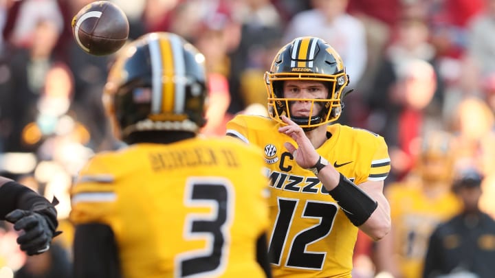 Nov 24, 2023; Fayetteville, Arkansas, USA; Missouri Tigers quarterback Brady Cook (12) passes to wide receiver Luther Burden III (3) during the second quarter against the Arkansas Razorbacks at Donald W. Reynolds Razorback Stadium. Mandatory Credit: Nelson Chenault-USA TODAY Sports