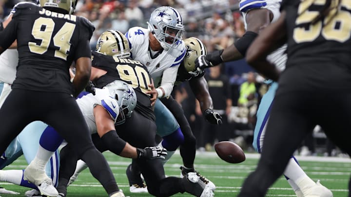 Sep 15, 2024; Arlington, Texas, USA; Dallas Cowboys quarterback Dak Prescott (4) fumbles in the second half against the New Orleans Saints at AT&T Stadium. 