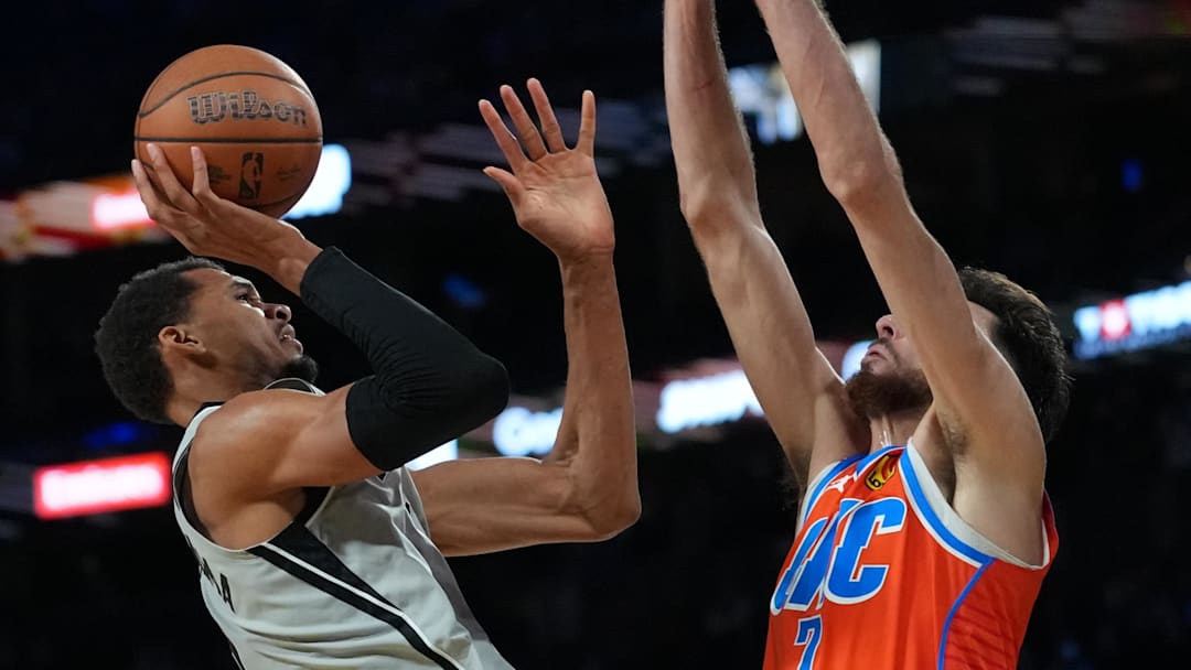 Dec 13, 2025; Las Vegas, Nevada, USA; San Antonio Spurs forward Victor Wembanyama (1) shoots over Oklahoma City Thunder center Chet Holmgren (7) during the fourth quarter at T-Mobile Arena. Mandatory Credit: Kirby Lee-Imagn Images