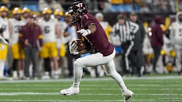 Jan 3, 2025; Charlotte, NC, USA; Virginia Tech Hokies cornerback Dante Lovett (1)  runs after his interception against the Minnesota Golden Gophers during the second half at the Duke’s Mayo Bowl at Bank of America Stadium. Mandatory Credit: Jim Dedmon-Imagn Images