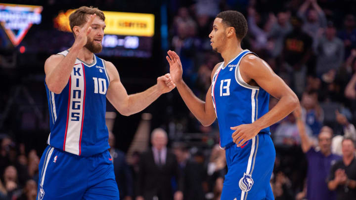 Dec 11, 2023; Sacramento, California, USA; Sacramento Kings forward Domantas Sabonis (10) and forward Keegan Murray (13) celebrate after scoring against the Brooklyn Nets during the fourth quarter at Golden 1 Center. Mandatory Credit: Ed Szczepanski-USA TODAY Sports