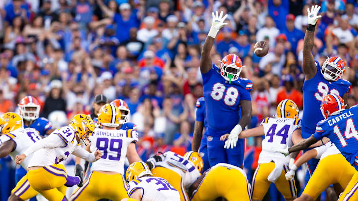 Caleb Banks (88) and Florida Gators defensive lineman Cam Jackson (99) try to block the kick. [Doug Engle/Gainesville Sun]