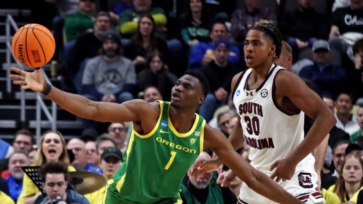 Mar 21, 2024; Pittsburgh, PA, USA; Oregon Ducks center N'Faly Dante (1) grabs a loose ball against South Carolina Gamecocks forward Collin Murray-Boyles (30) during the second half in the first round of the 2024 NCAA Tournament at PPG Paints Arena. Mandatory Credit: Charles LeClaire-USA TODAY Sports