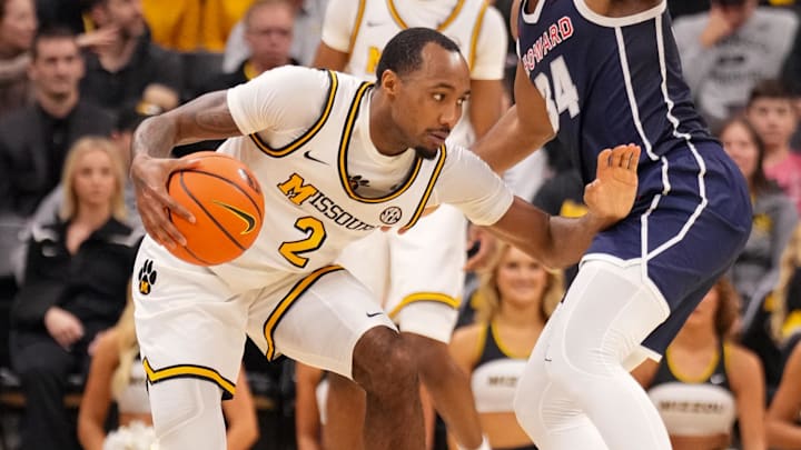 Nov 8, 2024; Columbia, Missouri, USA; Missouri Tigers guard Tamar Bates (2) controls the ball as Howard Bison guard Bryce Harris (34) defends during the second half at Mizzou Arena. Mandatory Credit: Denny Medley-Imagn Images