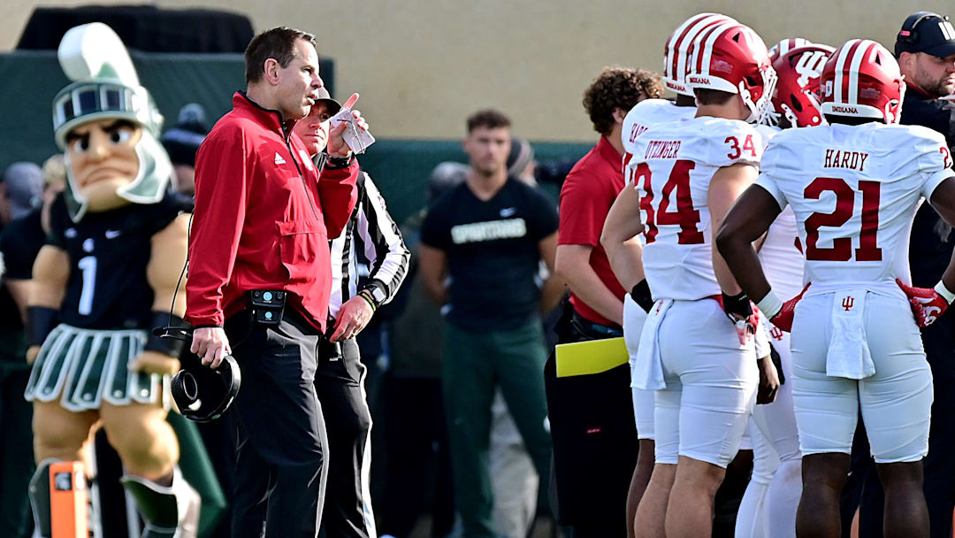 Nov 2, 2024; East Lansing, Michigan, USA;  Indiana Hoosiers head coach Curt Cignetti contests a call in the first quarter that resulted in a Michigan State Spartans touchdown at Spartan Stadium. Mandatory Credit: Dale Young-Imagn Images