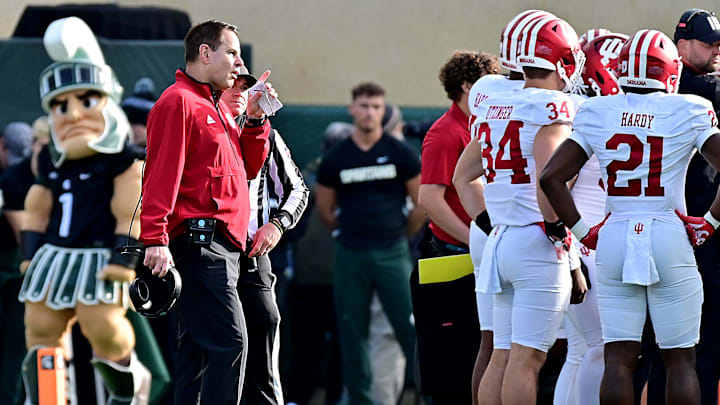 Nov 2, 2024; East Lansing, Michigan, USA;  Indiana Hoosiers head coach Curt Cignetti contests a call in the first quarter that resulted in a Michigan State Spartans touchdown at Spartan Stadium. Mandatory Credit: Dale Young-Imagn Images