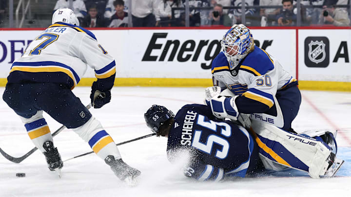 Apr 21, 2025; Winnipeg, Manitoba, CAN; Winnipeg Jets center Mark Scheifele (55) slides into St. Louis Blues goaltender Jordan Binnington (50) after being checked by St. Louis Blues defenseman Cam Fowler (17) in the second period in game two of the first round of the 2025 Stanley Cup Playoffs at Canada Life Centre. Mandatory Credit: James Carey Lauder-Imagn Images Apr 21, 2025; Winnipeg, Manitoba, CAN; Winnipeg Jets center Mark Scheifele (55) slides into St. Louis Blues goaltender Jordan Binnington (50) after being checked by St. Louis Blues defenseman Cam Fowler (17) in the second period in game two of the first round of the 2025 Stanley Cup Playoffs at Canada Life Centre. Mandatory Credit: James Carey Lauder-Imagn Images