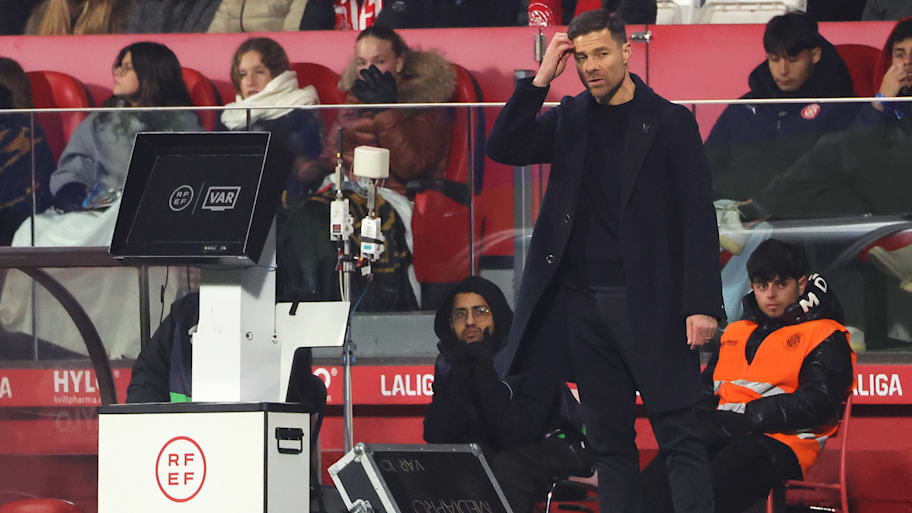 Xabi Alonso (right) next to a VAR booth.