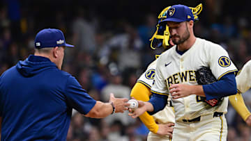 Milwaukee Brewers manager Pat Murphy makes a trip to the mound to pull relief pitcher Aaron Ashby.