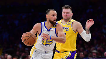 Apr 3, 2025; Los Angeles, California, USA; Golden State Warriors guard Stephen Curry (30) moves to the basket against Los Angeles Lakers guard Luka Doncic (77) during the second half at Crypto.com Arena. Mandatory Credit: Gary A. Vasquez-Imagn Images