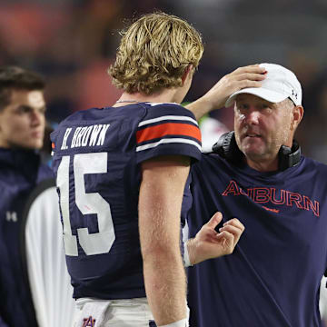 Auburn Tigers head coach Hugh Freeze talks with quarterback Hank Brown (15) during the fourth quarter against the New Mexico Lobos 