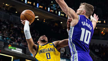 Feb 3, 2023; Indianapolis, Indiana, USA; Indiana Pacers guard Tyrese Haliburton (0) shoots the ball while Sacramento Kings forward Domantas Sabonis (10) defends in the second quarter at Gainbridge Fieldhouse. Mandatory Credit: Trevor Ruszkowski-Imagn Images