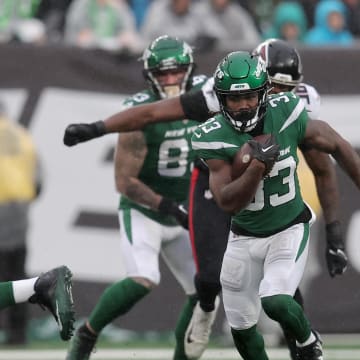 Dec 3, 2023; East Rutherford, New Jersey, USA; New York Jets running back Dalvin Cook (33) runs with the ball against the Atlanta Falcons during the first quarter at MetLife Stadium. Mandatory Credit: Brad Penner-USA TODAY Sports