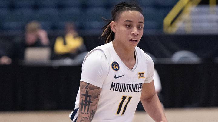 Dec 1, 2024; Estero, FL, USA; West Virginia University JJ Quinerly (11) dribbles the ball during the first quarter of the Women's Gulf Coast Showcase at Hertz Arena. Mandatory Credit: Chris Tilley-Imagn Images