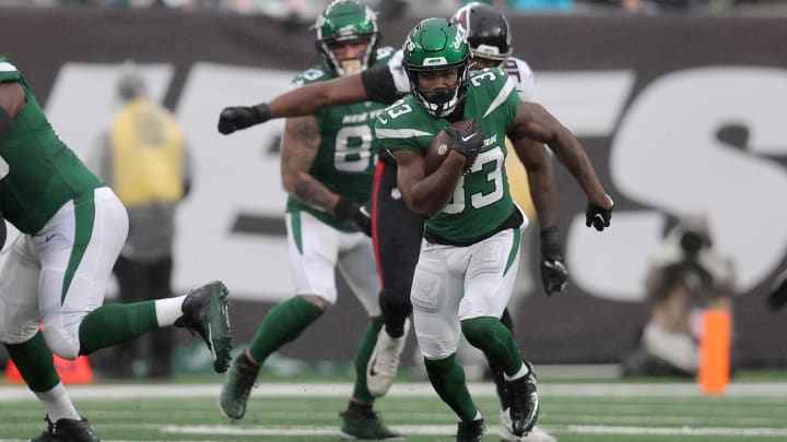 Dec 3, 2023; East Rutherford, New Jersey, USA; New York Jets running back Dalvin Cook (33) runs with the ball against the Atlanta Falcons during the first quarter at MetLife Stadium. Mandatory Credit: Brad Penner-USA TODAY Sports