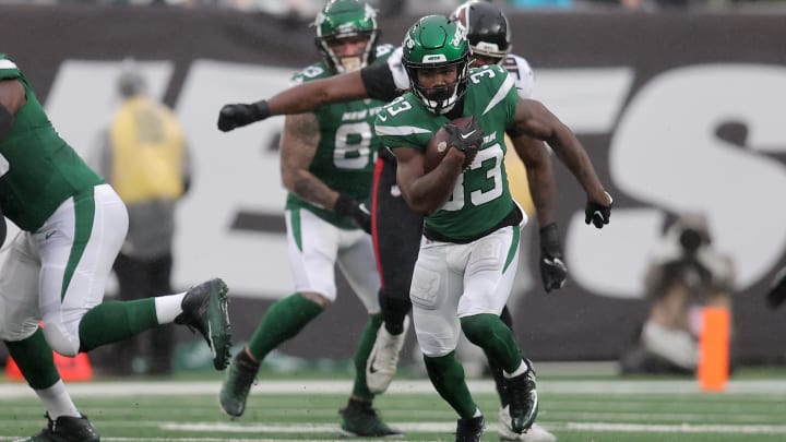 Dec 3, 2023; East Rutherford, New Jersey, USA; New York Jets running back Dalvin Cook (33) runs with the ball against the Atlanta Falcons during the first quarter at MetLife Stadium. 