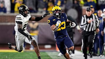 Michigan running back Jordan Marshall (23) runs against Purdue defensive back Tahj Ra-El (21) during the second half at Michigan Stadium in Ann Arbor on Saturday, November 1, 2025.