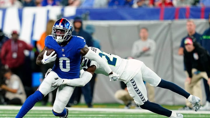 New York Giants wide receiver Parris Campbell (0) is tackled by Seattle Seahawks cornerback Devon Witherspoon (21) in the first half at MetLife Stadium on Monday, Oct. 2, 2023, in East Rutherford.