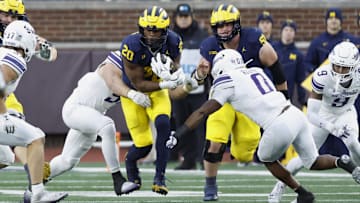 Nov 23, 2024; Ann Arbor, Michigan, USA;  Michigan Wolverines running back Kalel Mullings (20) runs the ball against the Northwestern Wildcats in the first half at Michigan Stadium. Mandatory Credit: Rick Osentoski-Imagn Images