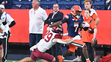 Sep 12, 2025; Syracuse, New York, USA; Syracuse Orange wide receiver Darien Williams (7) runs after making a catch with Colgate Raiders defensive back Connor Rowlison (29) defending in the fourth quarter at the JMA Wireless Dome. Mandatory Credit: Mark Konezny-Imagn Images