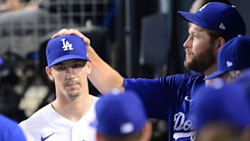 Jul 22, 2021; Los Angeles, California, USA; Los Angeles Dodgers pitcher Clayton Kershaw (22) greets starting pitcher Walker Buehler (21) after being relieved against the San Francisco Giants during the eighth inning at Dodger Stadium. Mandatory Credit: Gary A. Vasquez-Imagn Images