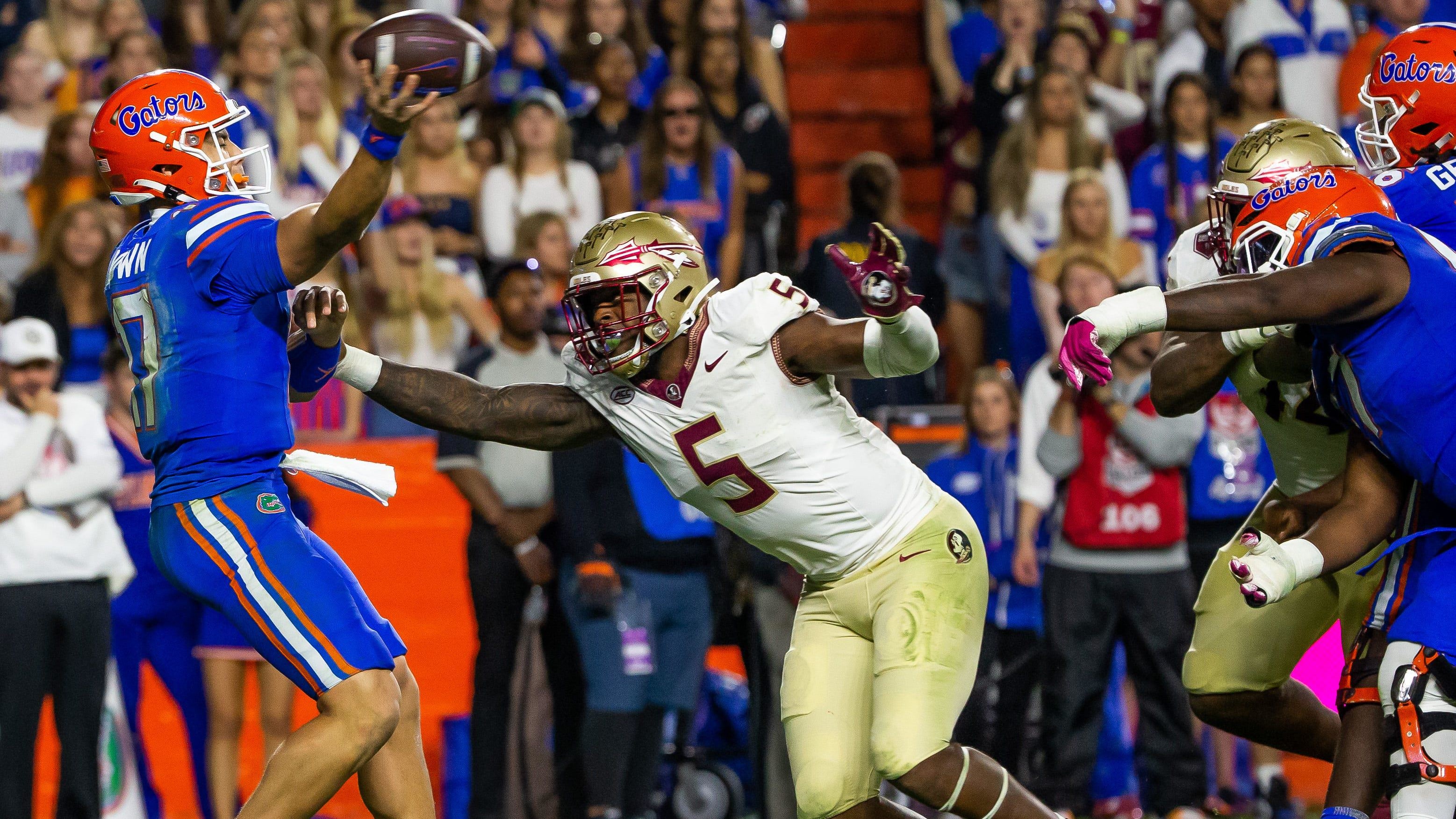Florida State Seminoles defensive lineman Jared Verse (5) pressures Florida Gators quarterback Max Brown.