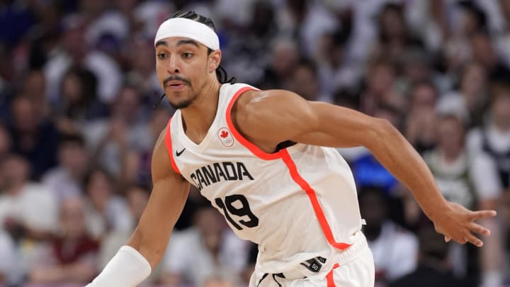 Aug 2, 2024; Villeneuve-d'Ascq, France; Canada point guard Andrew Nembhard (19) controls the ball against Spain in the second half in a men’s group A basketball game during the Paris 2024 Olympic Summer Games at Stade Pierre-Mauroy. Mandatory Credit: John David Mercer-USA TODAY Sports