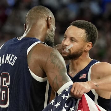 United States shooting guard Stephen Curry (4) and guard LeBron James (6) celebrate after defeating France in the men's basketball gold medal game during the Paris 2024 Olympic Summer Games at Accor Arena. Mandatory Credit: