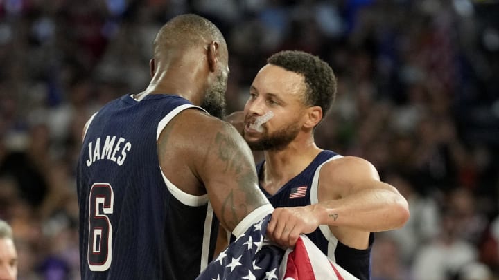 United States shooting guard Stephen Curry (4) and guard LeBron James (6) celebrate after defeating France in the men's basketball gold medal game during the Paris 2024 Olympic Summer Games at Accor Arena. Mandatory Credit: